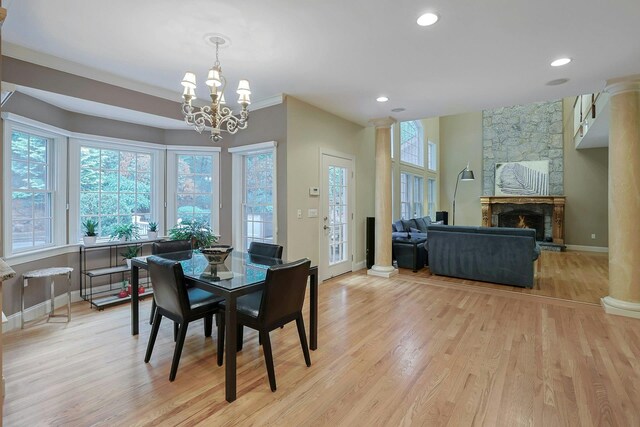 1988 Beekman Ct, Yorktown Heights, NY 10598 - dining space featuring light wood-type flooring, a fireplace, a chandelier, baseboards, and recessed lighting