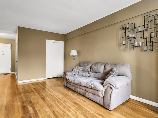 living room featuring light wood finished floors and baseboards