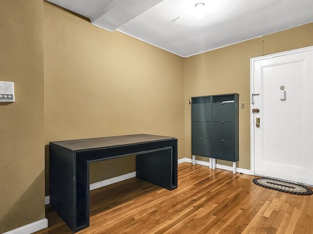 foyer with wood finished floors and baseboards
