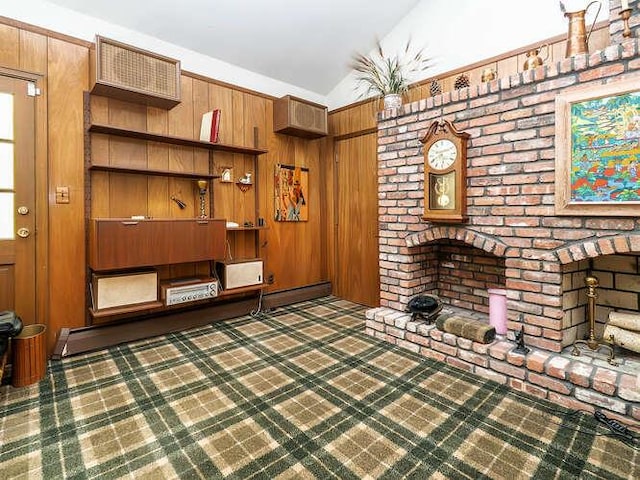 36 Lisa Dr, Dix Hills, NY 11746 - unfurnished living room with lofted ceiling, a fireplace, and wooden walls