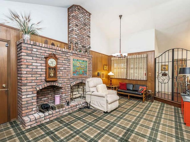 36 Lisa Dr, Dix Hills, NY 11746 - living room featuring wooden walls, a fireplace, a chandelier, and a towering ceiling