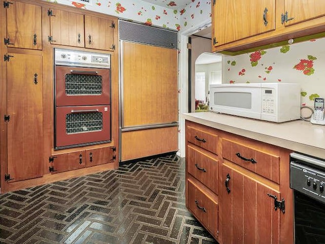 36 Lisa Dr, Dix Hills, NY 11746 - kitchen with double wall oven, paneled built in fridge, white microwave, and brick flooring