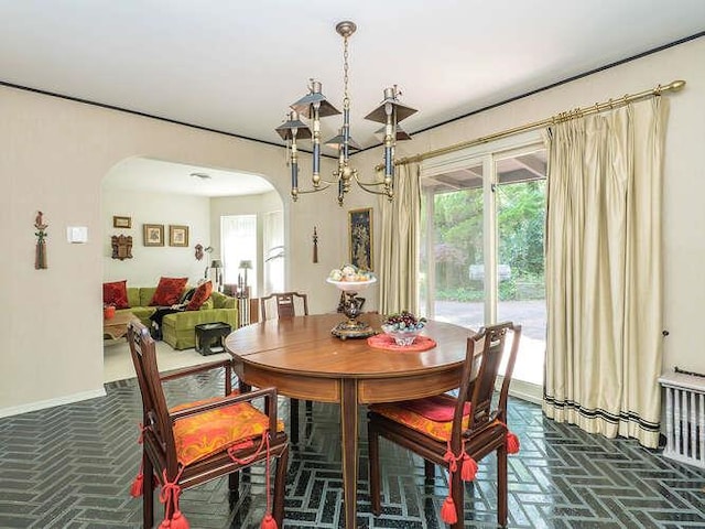 36 Lisa Dr, Dix Hills, NY 11746 - dining area featuring arched walkways, plenty of natural light, and a chandelier