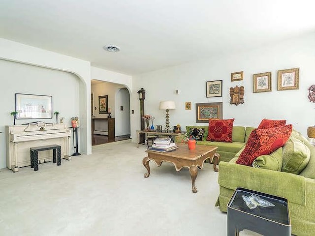 36 Lisa Dr, Dix Hills, NY 11746 - living room with arched walkways, a baseboard heating unit, and carpet