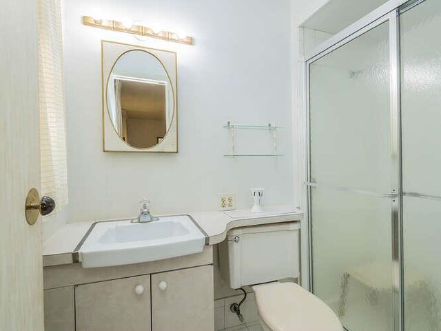 36 Lisa Dr, Dix Hills, NY 11746 - full bathroom with vanity, a shower with shower door, toilet, and tile patterned floors