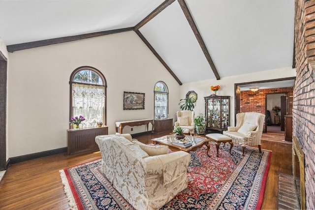 living area featuring beam ceiling, wood finished floors, high vaulted ceiling, and baseboards