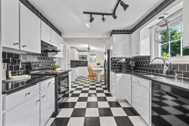 kitchen with black appliances, white cabinets, a sink, and dark countertops