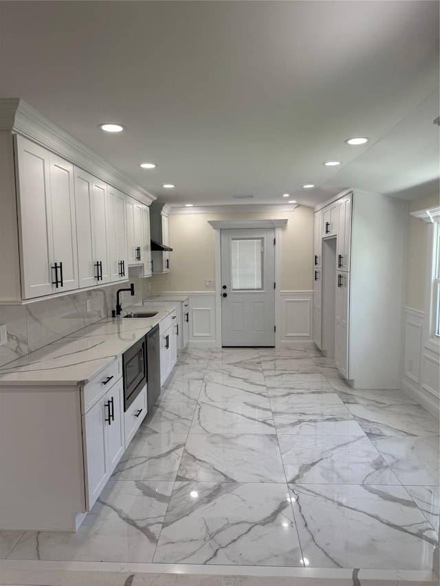 9 Henry St, Wyandanch, NY 11798 - kitchen with a sink, a decorative wall, recessed lighting, a wainscoted wall, and dishwashing machine