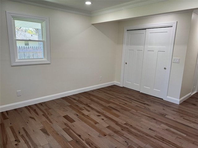 9 Henry St, Wyandanch, NY 11798 - unfurnished bedroom with wood finished floors, baseboards, crown molding, a closet, and recessed lighting