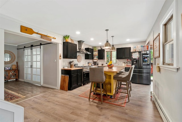 45 Proctor Rd, Eldred, NY 12732 - kitchen with high end stainless steel range, a baseboard heating unit, refrigerator with ice dispenser, wall chimney exhaust hood, and light countertops