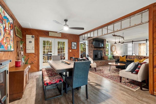 45 Proctor Rd, Eldred, NY 12732 - dining area with wood finished floors, a ceiling fan, french doors, a brick fireplace, and healthy amount of natural light