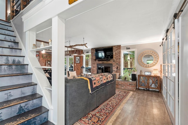 45 Proctor Rd, Eldred, NY 12732 - living area with stairs, wood finished floors, a brick fireplace, and ornamental molding