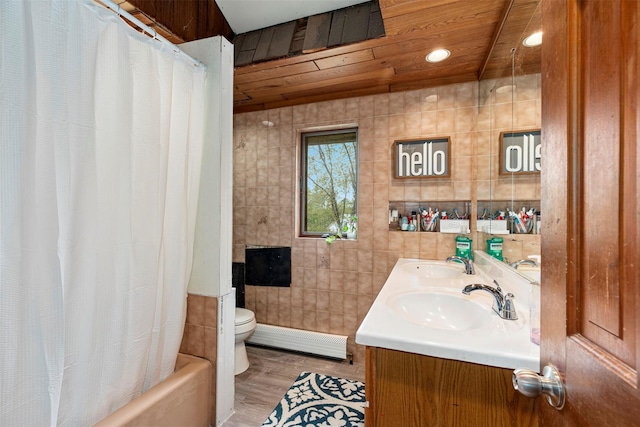 45 Proctor Rd, Eldred, NY 12732 - bathroom featuring baseboard heating, tile walls, toilet, wood finished floors, and double vanity