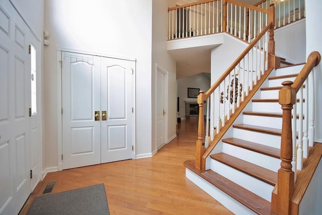 622 Creekside Ln, Fishkill, NY 12524 - foyer entrance featuring a towering ceiling, wood finished floors, baseboards, and stairway