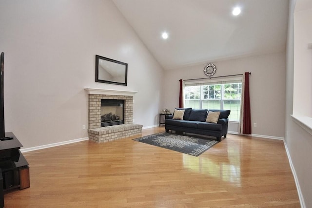 622 Creekside Ln, Fishkill, NY 12524 - living room with wood finished floors, high vaulted ceiling, a fireplace, baseboards, and recessed lighting