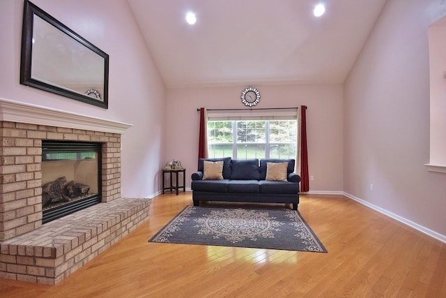 622 Creekside Ln, Fishkill, NY 12524 - living room with vaulted ceiling, wood finished floors, baseboards, a fireplace, and recessed lighting