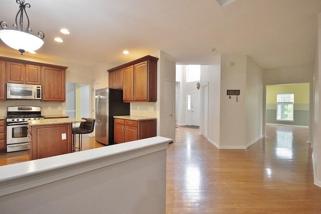 622 Creekside Ln, Fishkill, NY 12524 - kitchen featuring appliances with stainless steel finishes, tasteful backsplash, baseboards, light wood finished floors, and recessed lighting