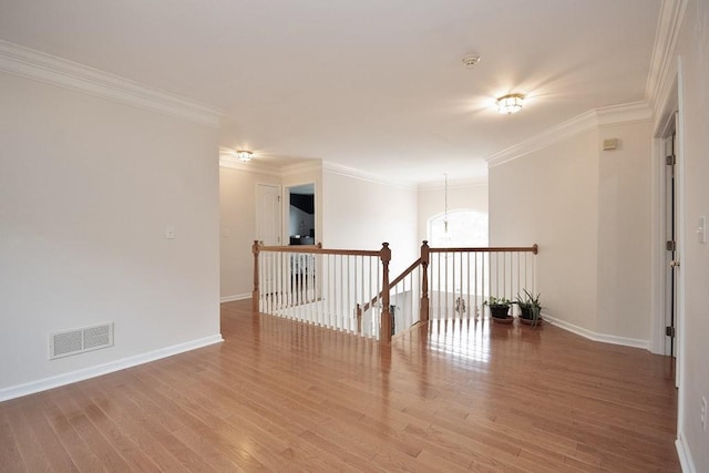 622 Creekside Ln, Fishkill, NY 12524 - empty room with wood finished floors, ornamental molding, baseboards, and a chandelier