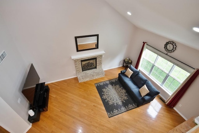 622 Creekside Ln, Fishkill, NY 12524 - living room featuring lofted ceiling, a brick fireplace, wood finished floors, baseboards, and recessed lighting