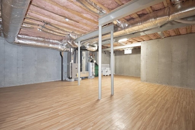 622 Creekside Ln, Fishkill, NY 12524 - unfinished basement with water heater, heating unit, and wood finished floors