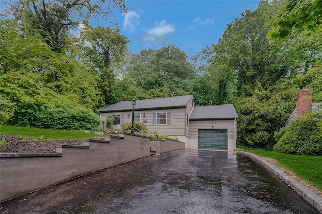 155 Woodbury Rd, Huntington, NY 11743 - view of front of house with an attached garage, driveway, and a chimney