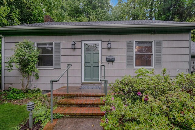 155 Woodbury Rd, Huntington, NY 11743 - property entrance with a chimney and a shingled roof