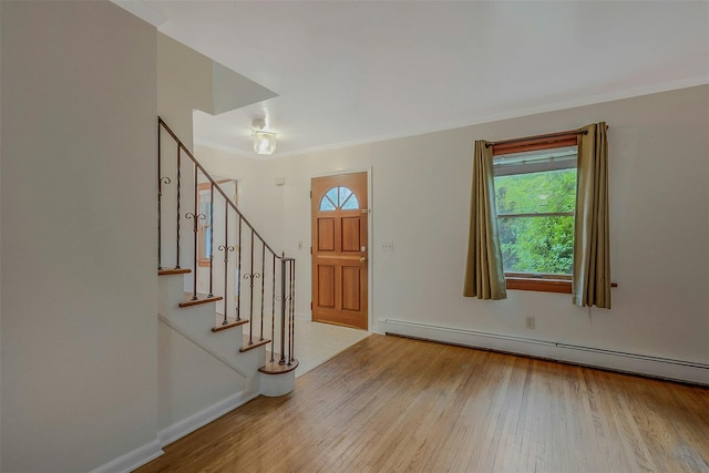 155 Woodbury Rd, Huntington, NY 11743 - entryway with a baseboard heating unit, crown molding, wood-type flooring, stairs, and baseboards