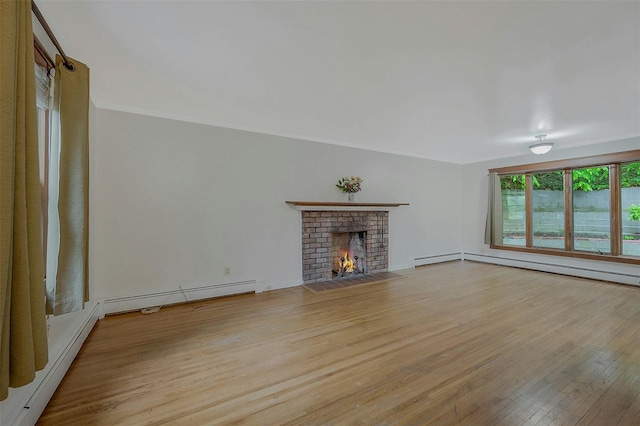 155 Woodbury Rd, Huntington, NY 11743 - unfurnished living room featuring a baseboard radiator, wood finished floors, a fireplace, and crown molding