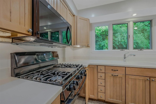 155 Woodbury Rd, Huntington, NY 11743 - kitchen with black gas range, a sink, light countertops, and light brown cabinetry