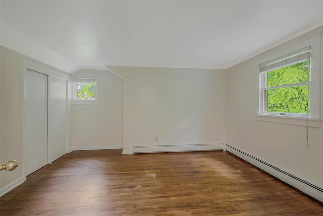 155 Woodbury Rd, Huntington, NY 11743 - additional living space featuring a baseboard heating unit, wood finished floors, vaulted ceiling, and baseboards