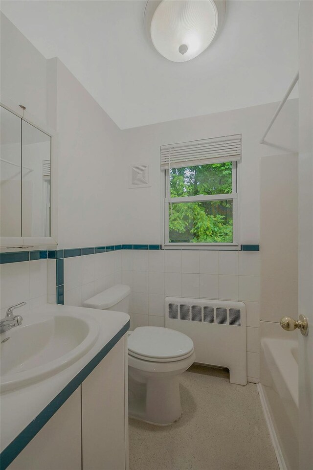 155 Woodbury Rd, Huntington, NY 11743 - full bath featuring radiator heating unit, tile walls, vanity, toilet, and wainscoting