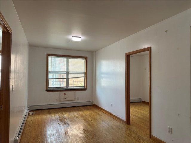 7177 159th St Unit 205, Flushing, NY 11365 - empty room featuring wood finished floors and baseboard heating