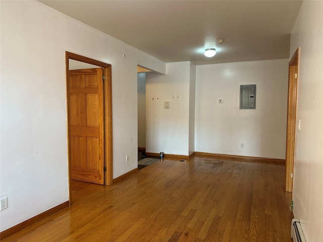 7177 159th St Unit 205, Flushing, NY 11365 - empty room featuring a baseboard radiator, wood finished floors, electric panel, and baseboards