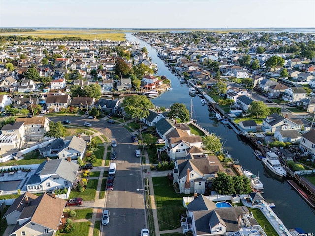 aerial view of property's location featuring nearby suburban area and a large body of water