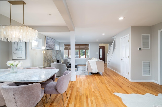 dining area featuring stairway, light wood-style flooring, baseboards, a chandelier, and recessed lighting
