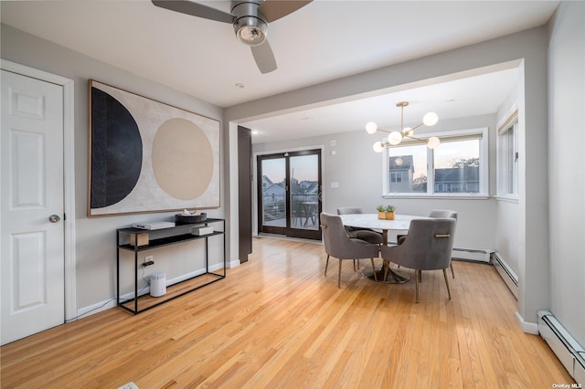 dining room with a baseboard heating unit, light wood-style floors, a chandelier, and a ceiling fan