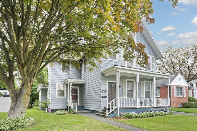 view of front facade with covered porch and a front lawn