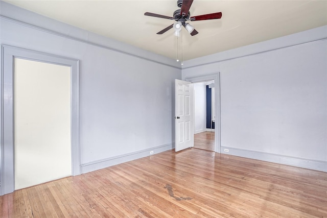 unfurnished room with hardwood / wood-style floors, ceiling fan, and baseboards