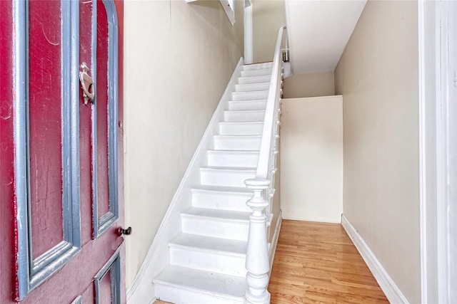 stairway with wood finished floors