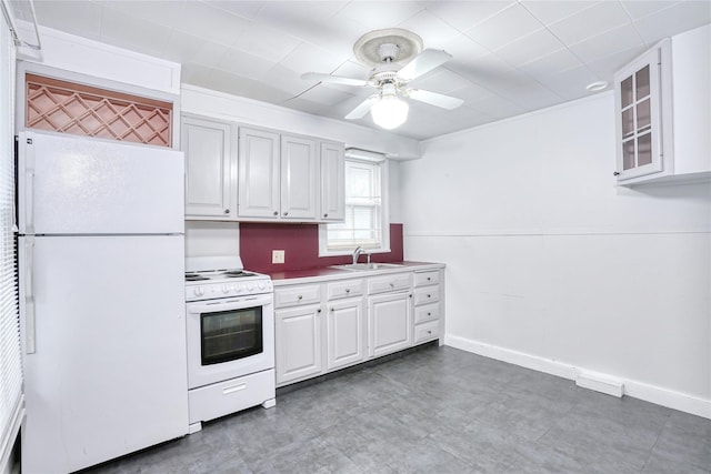kitchen with white appliances, a sink, ceiling fan, white cabinets, and glass insert cabinets