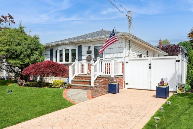 75 Massachusetts Ave, Massapequa, NY 11758 - view of front of house featuring a gate and a front lawn