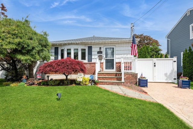 75 Massachusetts Ave, Massapequa, NY 11758 - bungalow-style home with a gate and brick siding