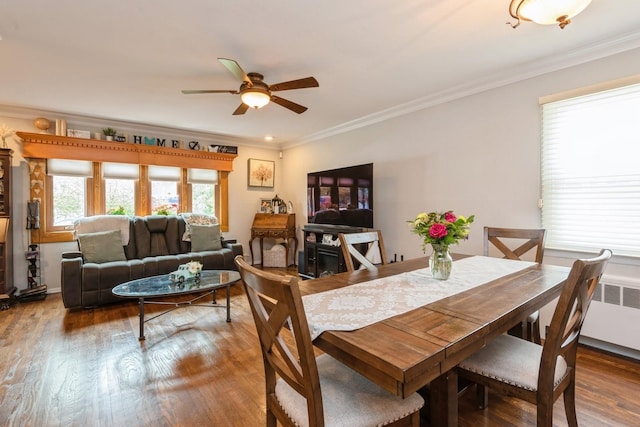 75 Massachusetts Ave, Massapequa, NY 11758 - dining area featuring radiator heating unit, ceiling fan, crown molding, and wood finished floors