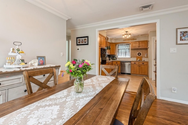 75 Massachusetts Ave, Massapequa, NY 11758 - dining space with ornamental molding, a chandelier, light wood finished floors, and baseboards