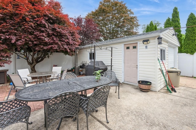 75 Massachusetts Ave, Massapequa, NY 11758 - view of patio / terrace with outdoor dining space, an outbuilding, and a grill