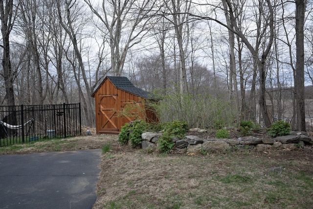view of shed with fence