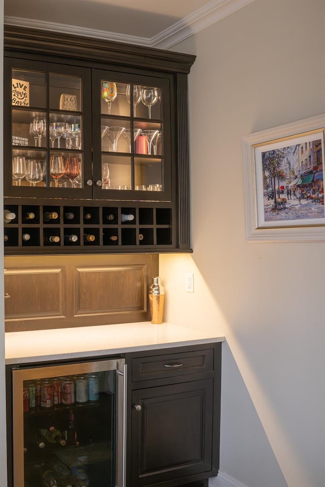 indoor dry bar with wine cooler and ornamental molding