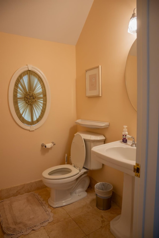 bathroom featuring toilet, tile patterned floors, and lofted ceiling