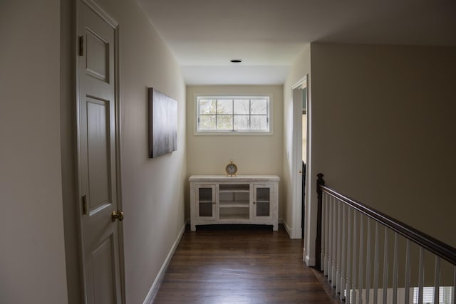 hall featuring dark wood finished floors and baseboards