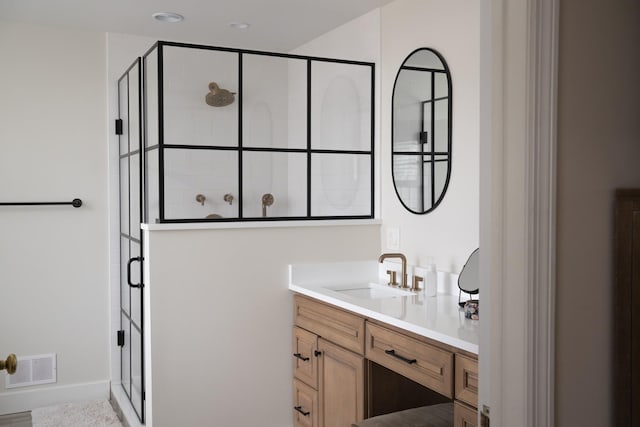full bathroom with a shower stall, vanity, and baseboards